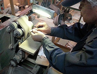 A Michihamono craftsman grinding a carving knife blade in Miki City, Japan